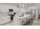 Modern kitchen with white cabinets, an island with seating, and stainless steel appliances at 130 W Crescent Mills Blvd # Homesite 251, Wilson's Mills, NC 27520
