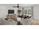Comfortable living room featuring stylish furniture, a modern ceiling fan, and natural light at 130 W Crescent Mills Blvd # Homesite 251, Wilson's Mills, NC 27520