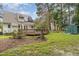 A spacious backyard features a wooden deck and a storage shed, with solar panels on the roof at 1316 Raybon Dr, Wendell, NC 27591