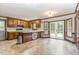 Kitchen and eat-in area offering a sunny view, wood cabinets and laminate countertops at 1316 Raybon Dr, Wendell, NC 27591