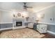 Cozy living room with a painted brick fireplace, a ceiling fan, and comfortable seating at 1316 Raybon Dr, Wendell, NC 27591