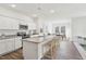 Bright, modern kitchen with stainless steel appliances and a large island with granite countertops at 140 Oat Grain Ct, Clayton, NC 27520