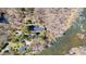 Aerial view of house with mature trees and beautiful river frontage at 1405 N Sellars Mill Rd, Burlington, NC 27217