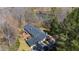 Aerial view of home with mature trees, fenced yard and large deck at 1405 N Sellars Mill Rd, Burlington, NC 27217