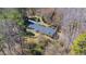 Aerial view of home with mature trees, fenced yard and large deck at 1405 N Sellars Mill Rd, Burlington, NC 27217