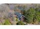 Beautiful aerial view of a home nestled among trees with a serene river backdrop at 1405 N Sellars Mill Rd, Burlington, NC 27217