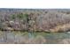 Aerial view of home with mature trees, on a river at 1405 N Sellars Mill Rd, Burlington, NC 27217