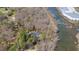 Aerial view of house with mature trees and beautiful river frontage at 1405 N Sellars Mill Rd, Burlington, NC 27217