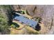 Aerial view of home with mature trees, fenced yard and large deck at 1405 N Sellars Mill Rd, Burlington, NC 27217