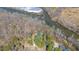 Aerial view of house with mature trees and beautiful river frontage at 1405 N Sellars Mill Rd, Burlington, NC 27217