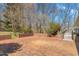 Brick patio in the backyard with a small brick wall and natural landscaping, offering a tranquil outdoor space at 1405 N Sellars Mill Rd, Burlington, NC 27217