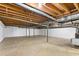 Unfinished basement with concrete floor, exposed ceiling, and support beams, ready for customization at 1405 N Sellars Mill Rd, Burlington, NC 27217