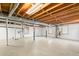 Unfinished basement with painted walls and exposed ceiling beams at 1405 N Sellars Mill Rd, Burlington, NC 27217