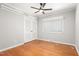 Comfortable bedroom with hardwood floors, ceiling fan, closet, and a large window at 1405 N Sellars Mill Rd, Burlington, NC 27217