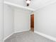 Comfortable bedroom features a ceiling fan, neutral carpet, and access to a brick-walled room at 1405 N Sellars Mill Rd, Burlington, NC 27217