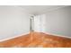 A bedroom with original hardwood flooring, base molding and fresh paint at 1405 N Sellars Mill Rd, Burlington, NC 27217