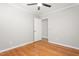 The bedroom has hardwood flooring and an open door that leads into another room at 1405 N Sellars Mill Rd, Burlington, NC 27217
