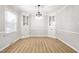 Bright dining room featuring built-in cabinets, a large window, and elegant lighting at 1405 N Sellars Mill Rd, Burlington, NC 27217