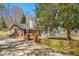 Beautiful home with brick accents, a carport, and a charming porch, surrounded by mature trees at 1405 N Sellars Mill Rd, Burlington, NC 27217