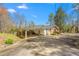 Charming home exterior with an attached carport and a well-maintained front yard at 1405 N Sellars Mill Rd, Burlington, NC 27217