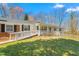 Attractive home with brick accents, a white porch, and a well-maintained lawn in a serene setting at 1405 N Sellars Mill Rd, Burlington, NC 27217