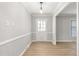 Bright foyer featuring stylish flooring, decorative trim, and a glass-paneled front door at 1405 N Sellars Mill Rd, Burlington, NC 27217