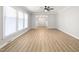 Spacious living room featuring vinyl floors, a ceiling fan, recessed lighting, and ample natural light at 1405 N Sellars Mill Rd, Burlington, NC 27217