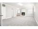 Open-concept living room with neutral walls, plush carpet, fireplace, and ample natural light creating a bright and airy space at 1405 N Sellars Mill Rd, Burlington, NC 27217