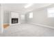 Expansive living room features a fireplace, plush carpeting, and natural light from large windows at 1405 N Sellars Mill Rd, Burlington, NC 27217
