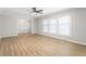 Bright living room featuring modern flooring, large windows, a ceiling fan, and an open doorway at 1405 N Sellars Mill Rd, Burlington, NC 27217