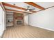 This living room includes a brick fireplace, built-in shelves, wood-look flooring, and a ceiling fan at 1405 N Sellars Mill Rd, Burlington, NC 27217