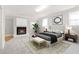 This main bedroom features a fireplace, an area rug, and two bedside lamps on either side of the bed at 1405 N Sellars Mill Rd, Burlington, NC 27217