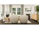 Bright living room with modern furnishings, fireplace, and large windows that provide lots of natural light at 1564 Bright Coral Trl, Wendell, NC 27591