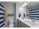 Well-lit bathroom with a double sink vanity, large mirror, and tiled floor, offering a clean and functional space at 1725 Langlais Dr, Graham, NC 27253