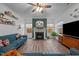 Cozy living room featuring a fireplace, hardwood floors, a ceiling fan, and a comfortable sofa at 1725 Langlais Dr, Graham, NC 27253