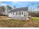 Expansive backyard featuring a spacious deck, concrete patio, and lush green space at 173 Allie Dr, Garner, NC 27529