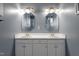 Bright bathroom features double sinks and vanities with decorative mirrors and gold hardware at 173 Allie Dr, Garner, NC 27529