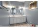 Bright bathroom features double sinks and vanities with decorative mirrors and gold hardware at 173 Allie Dr, Garner, NC 27529