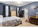 Spacious bedroom with a large bed, carpet floors, and a view into the attached bathroom at 173 Allie Dr, Garner, NC 27529