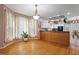 Charming dining area with hardwood floors, decorative chandelier, and seamless transition to the kitchen at 173 Allie Dr, Garner, NC 27529
