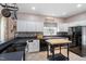 Bright kitchen features white cabinets, black countertops, an island, and stainless steel appliances at 173 Allie Dr, Garner, NC 27529