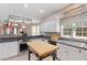 Bright kitchen with white cabinets, black countertops, an island, and stainless steel appliances at 173 Allie Dr, Garner, NC 27529