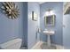 Cozy powder room features a pedestal sink, toilet, and decorative lighting at 173 Allie Dr, Garner, NC 27529