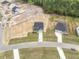 Aerial view of new construction home featuring a driveway and landscaping at 173 Wild Turkey Way, Lillington, NC 27546