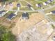 Aerial view of home surrounded by empty lots with foundation work underway at 173 Wild Turkey Way, Lillington, NC 27546