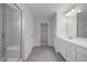 A modern bathroom with a glass shower and double sink vanity at 173 Wild Turkey Way, Lillington, NC 27546