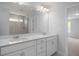 Bright bathroom featuring double sinks, quartz counters, and glass enclosed shower at 173 Wild Turkey Way, Lillington, NC 27546