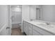 Modern bathroom featuring double vanity with white cabinets and solid surface countertop at 173 Wild Turkey Way, Lillington, NC 27546