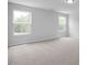 Spacious bedroom with neutral carpet, light gray walls, natural light, and modern design at 173 Wild Turkey Way, Lillington, NC 27546
