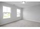 Cozy bedroom featuring plush carpet and abundant natural light at 173 Wild Turkey Way, Lillington, NC 27546